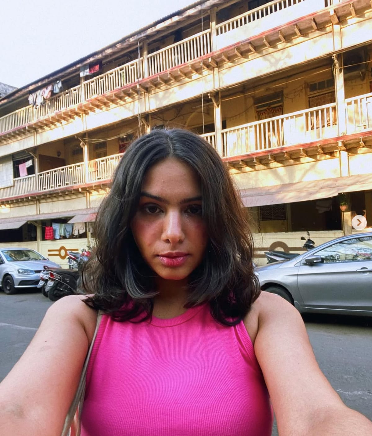 Manisha, sitting in a courtyard