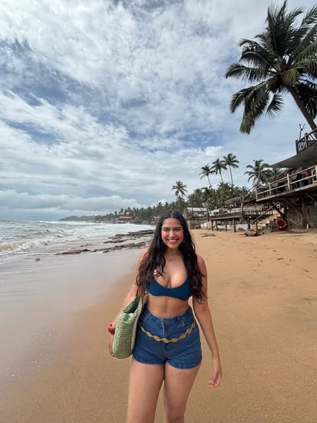 Walking a Goa beach under palms and a grey sky